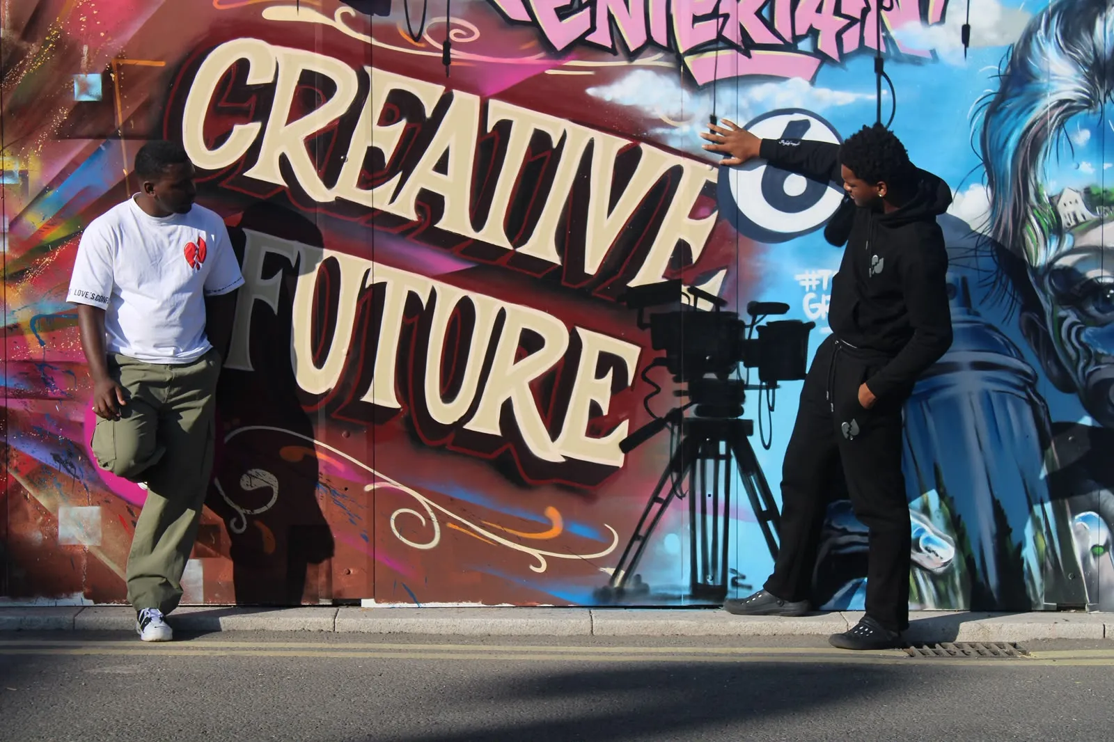 Two LVOE wearers photographed on a mural-covered street